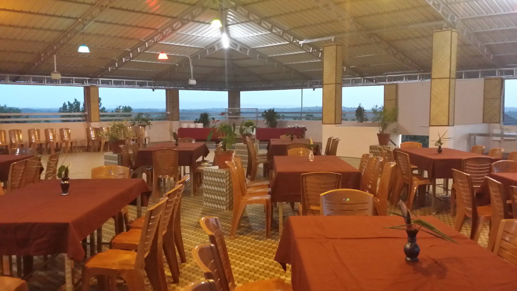 Rooftop dining space with panoramic views at Yamunatheeram Resort